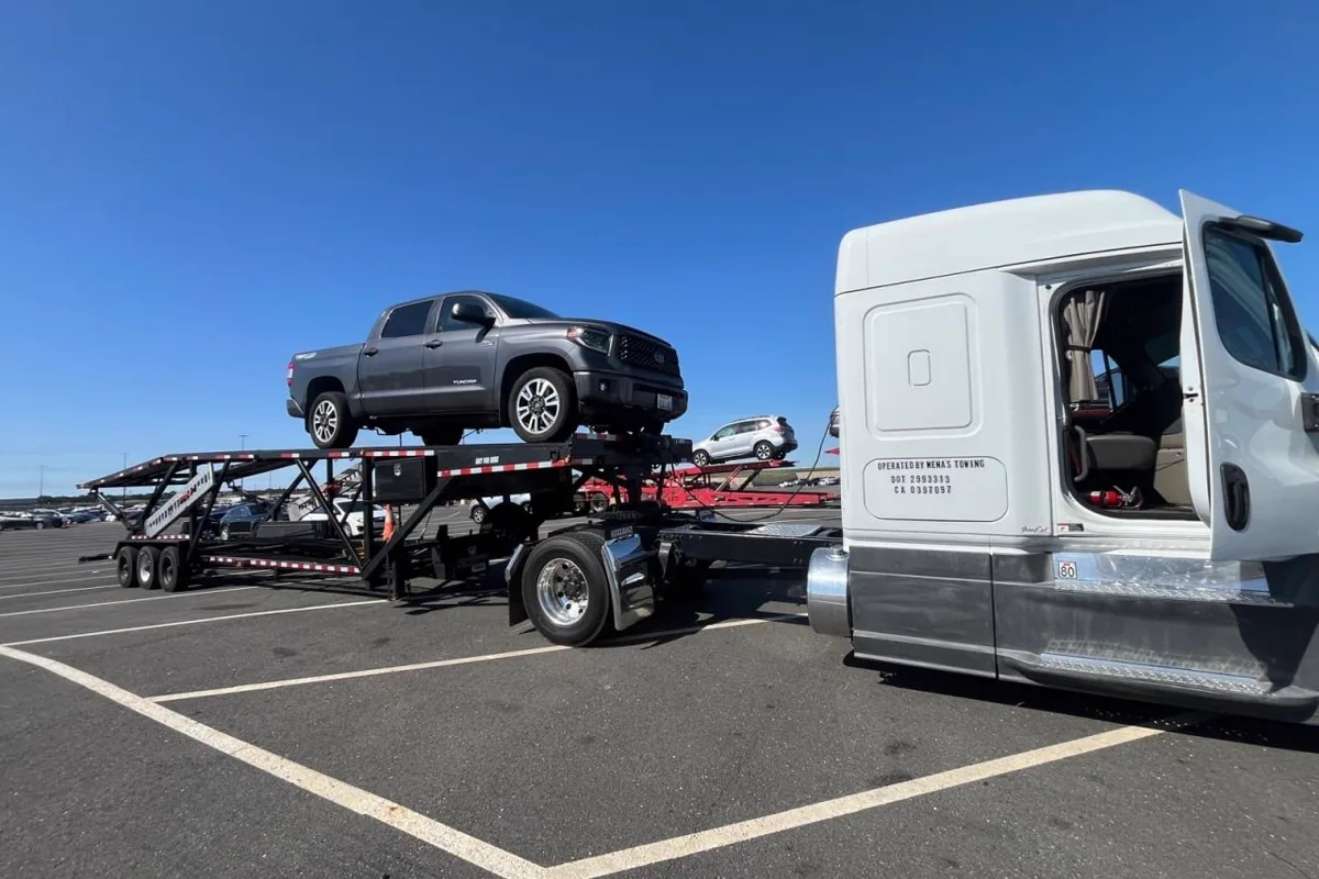 Mena's Towing multi-car carrier transporting vehicles across California
